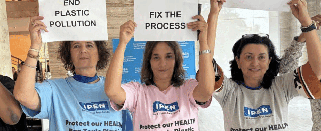 3 IPNers holding up signs at INC5.2